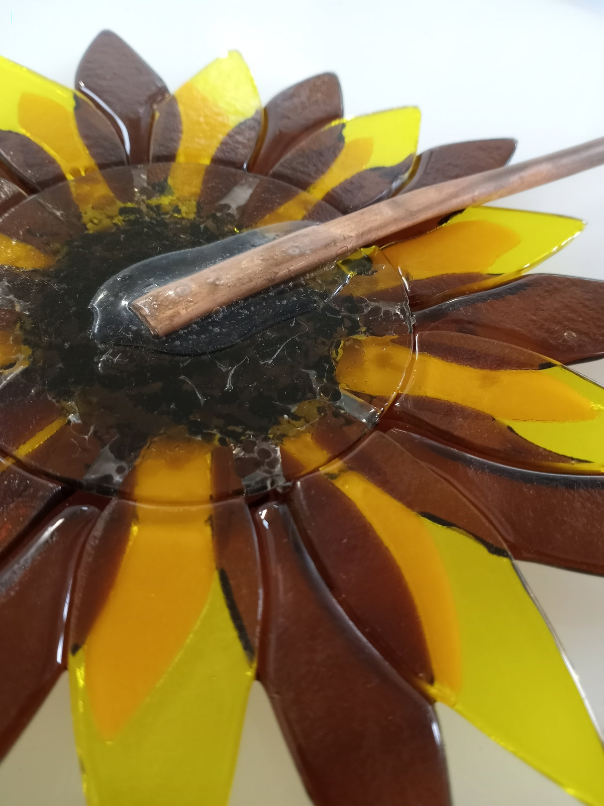 1/8" copper tube hammered flat and glued to back of fused glass flower