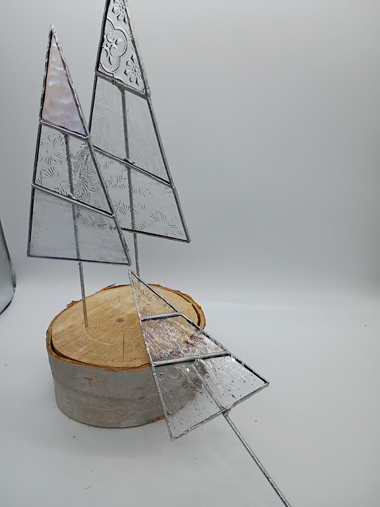 3 stained glass trees on a birch log