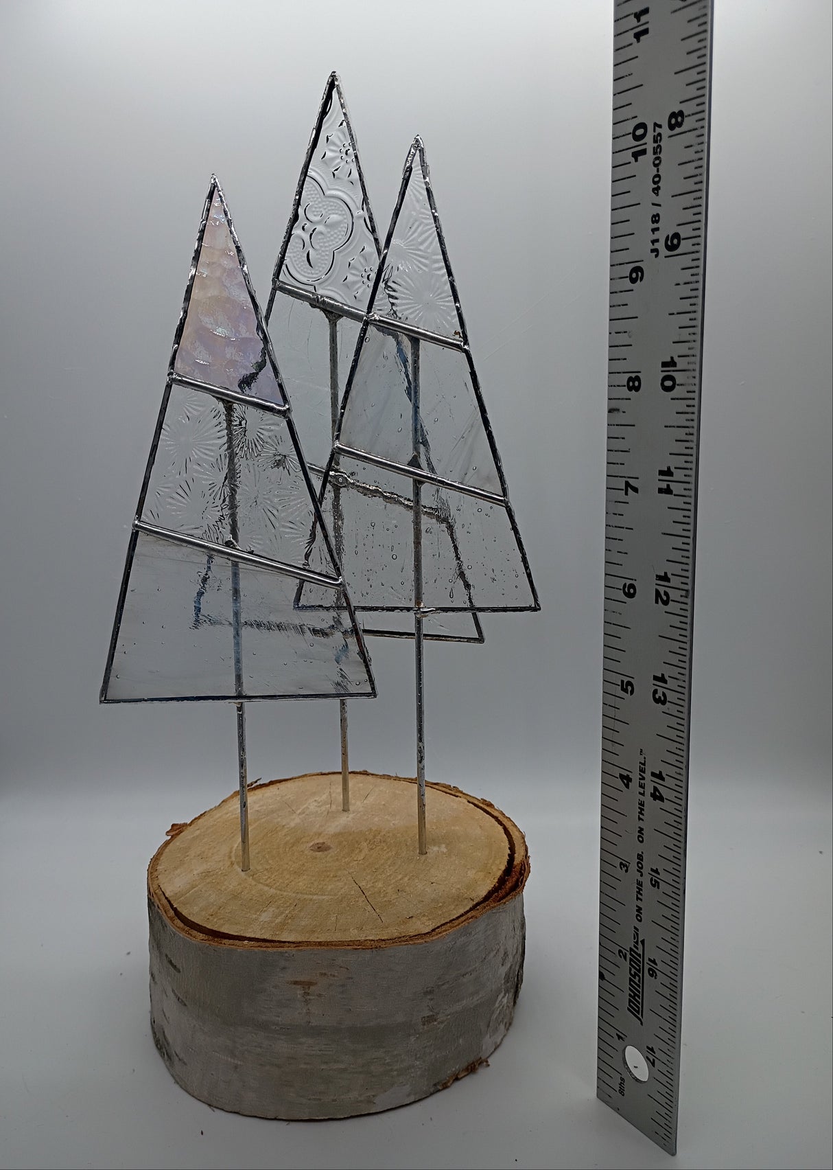 three stained glass trees with ruler showing 10 inch height