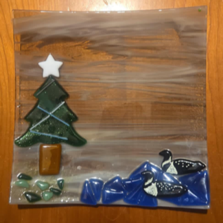 A fused glass plate showing the painted loons