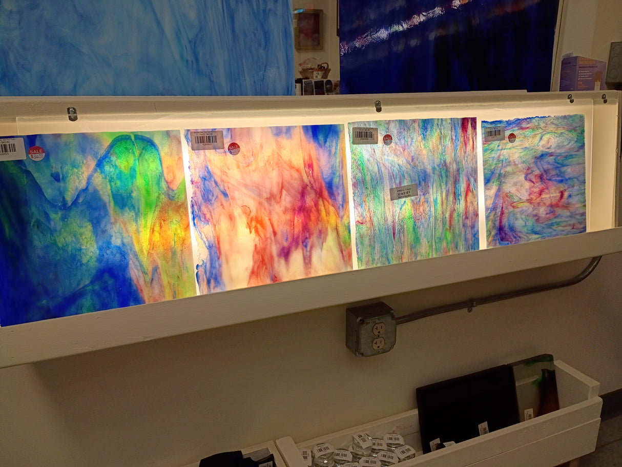 Four pieces of YU6585G glass lined up on a light box