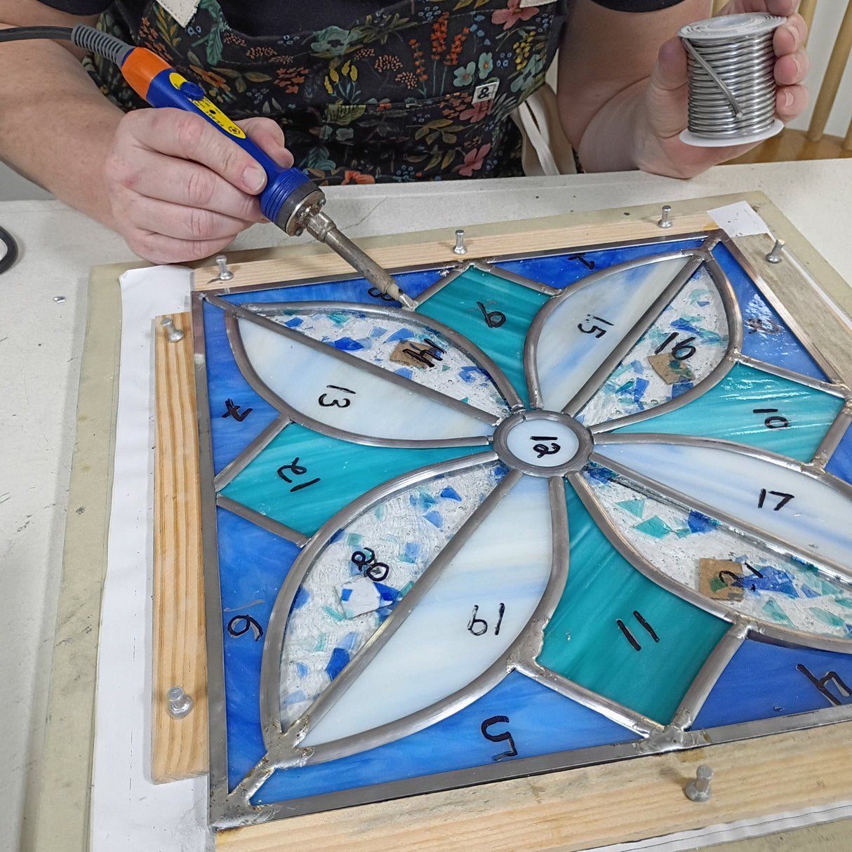 person soldering a lead came panel