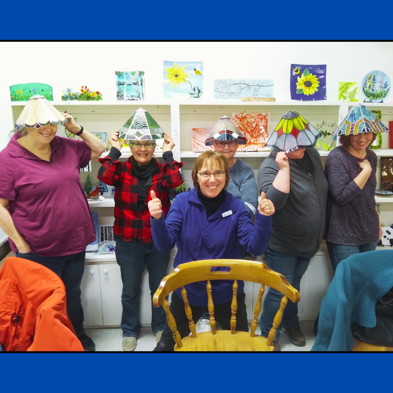 students wearing their stained glass lamps on their heads