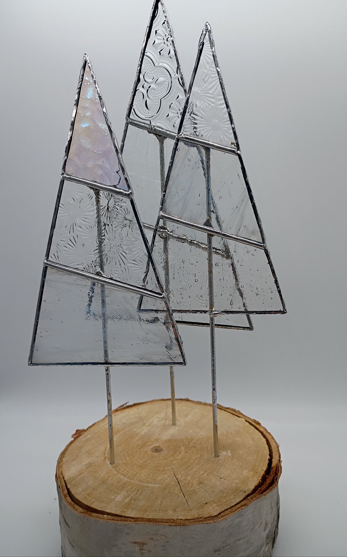 3 stained glass trees on a birch log