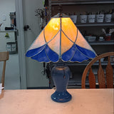 Table lamp with stained glass shade on a wooden table