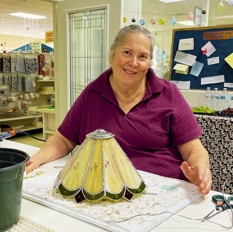 Student making stained glass lampshade