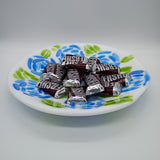 Assorted Hershey's chocolate bars on a decorative plate with floral patterns