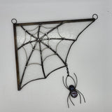stained glass spiderweb with clear textured glass and a black spider