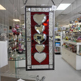 Decorative stained glass panel with heart designs in a store setting
