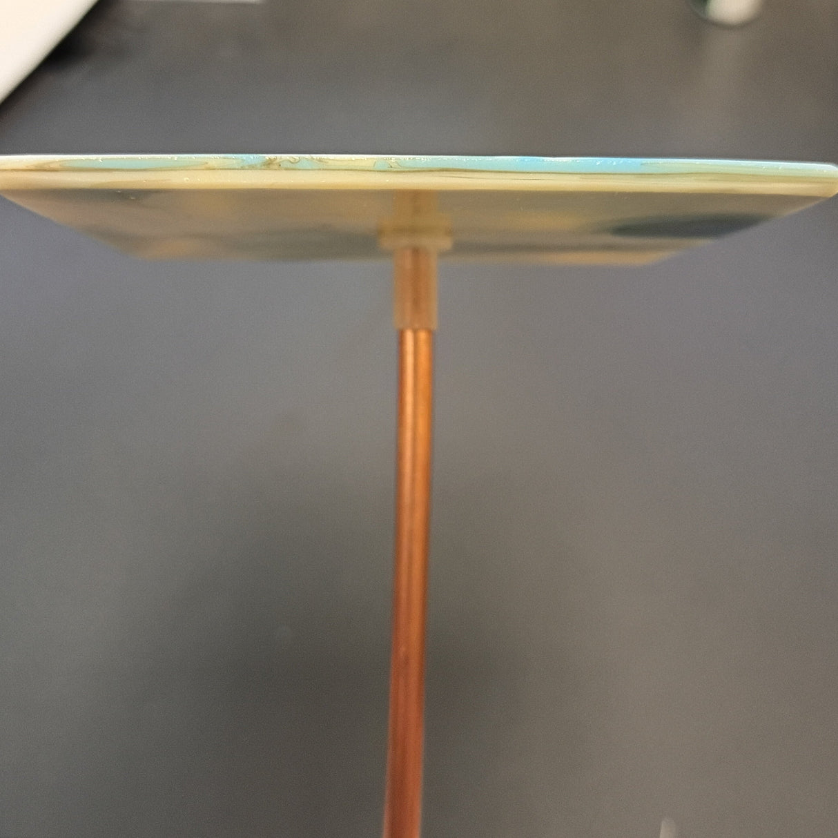 plastic washer attached to glass and copper rod for plant stake